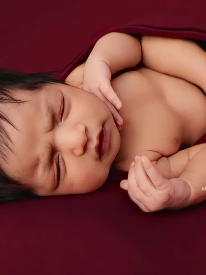 A side profile of the 'potato sack' pose, showing how securely and comfortably the baby is wrapped.