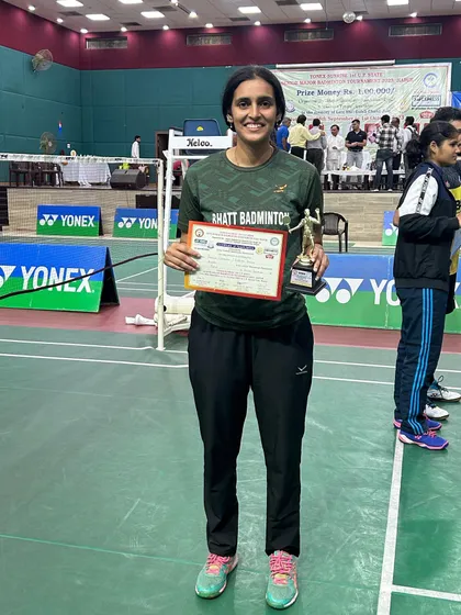 Shailja Shukla, a trainee at my academy, holds her trophy after winning the Women's Doubles gold medal at the Hapur state tournament.