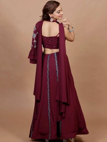 The back of this maroon lehenga set reveals a stylish cut-out design. I believe every angle of an outfit should be interesting, and this piece is designed to look stunning from all sides.