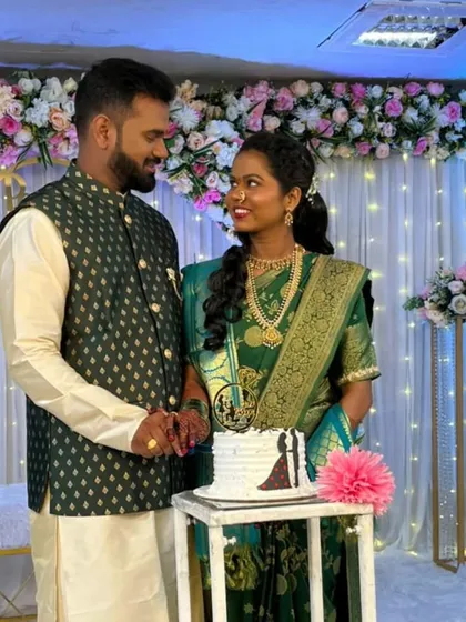 The couple enjoying their cake cutting ceremony against the backdrop of our fairy light and floral stage decoration.