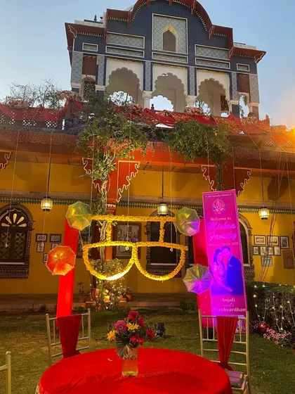 Fun and quirky decor for a sangeet or mehendi, featuring a large, lit-up pair of sunglasses as a central prop.