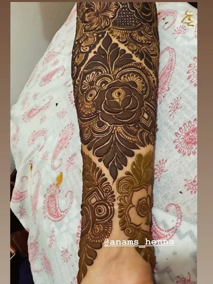 I love using roses as a central element in my bridal designs. Here, a large, shaded rose on the forearm is surrounded by intricate patterns, creating a romantic and classic bridal look.