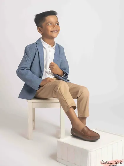 A classic seated portrait with a forward-looking gaze. This shot has a wonderfully optimistic feel, perfect for a birthday milestone. My goal in kids' fashion photography is to create images that are both stylish and full of life.