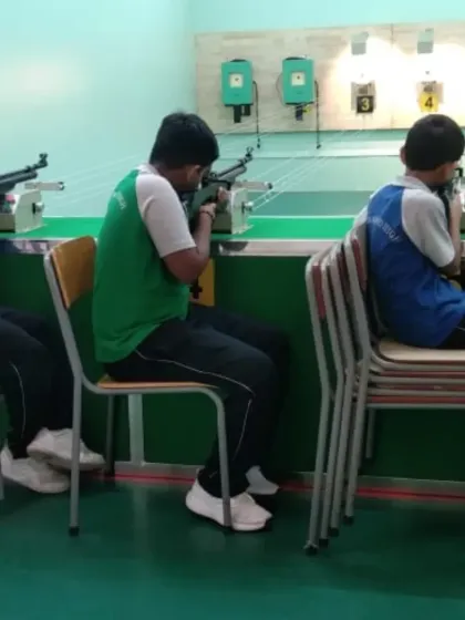 Students practice from a seated position, a common training method to help beginners focus on upper body stability and aiming technique. We use varied training setups to build a strong foundation of skills.
