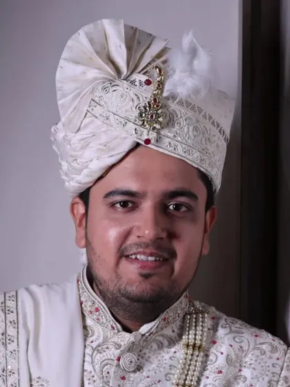 A portrait of the groom looking confident and happy. The natural makeup finish ensures the skin looks healthy and radiant.