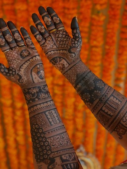A stunning bridal design set against a vibrant marigold backdrop, perfect for a mehendi ceremony.