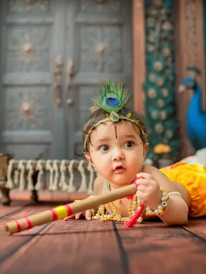 A tummy-time pose for the little Krishna, perfect for capturing the 3-4 month milestone.