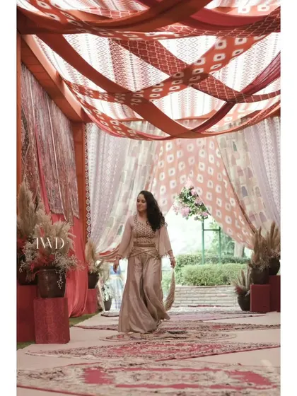 Our co-founder personally reviews every detail before an event begins. Here, she is inspecting the setup of our 'Souk at Fatehpur' Mehendi, ensuring every element is perfect.