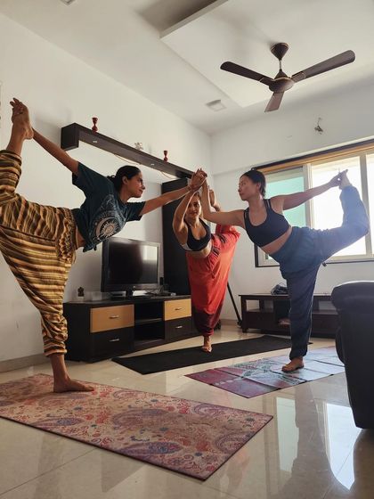 Three of us finding our balance and alignment together in Natarajasana (Dancer's Pose). Practicing with others brings a special kind of energy and joy.