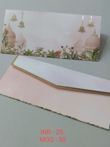 A beautiful money envelope showcasing majestic peacocks and lotus flowers against a subtly striped background. The gold foil on the peacock feathers adds a touch of opulence.