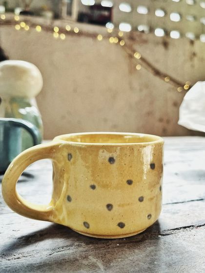 After her beginner's course, this student rejoined for the advanced level. She created beautiful wheel-thrown mugs and bowls, and also explored sculptural hand-building, creating this unique candlestick holder.