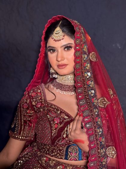 A close-up portrait of the bride. The makeup is kept classic and radiant, enhancing her natural features.