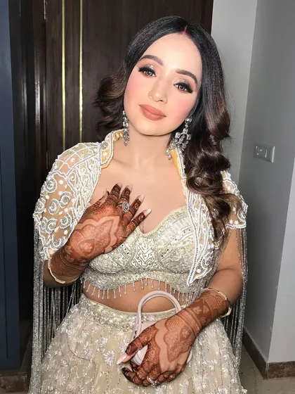 A playful pose showing off her mehndi and the beautiful movement of her earrings.