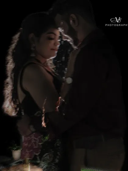 An artistic and moody pre-wedding portrait using rim lighting to create a beautiful silhouette of the couple's embrace.