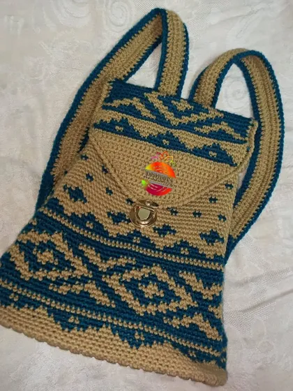 This tapestry crochet backpack shows a different style of my work, featuring an intricate geometric pattern. It's lightweight yet spacious, with a secure flap closure and adjustable shoulder straps, making it ideal for college or daily use.
