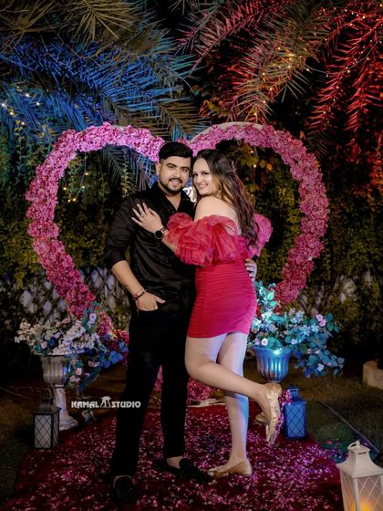 The first portrait as a newly engaged couple, posing in front of the beautiful proposal decor. A perfect shot to announce the happy news.