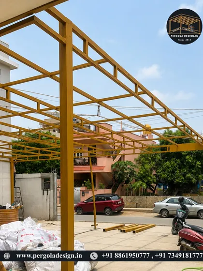 The skeleton of a premium carport taking shape. This view highlights the heavy-duty square pillars and the intricate grid of the roof frame, all fabricated in-house to our exact design specifications. This ensures structural integrity and a flawless final product.