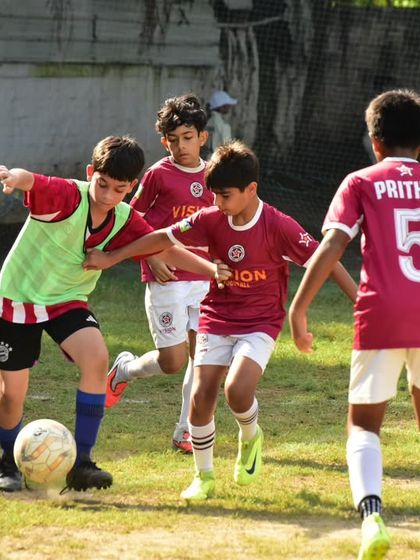A tough battle in the midfield as our players work together to win possession of the ball.