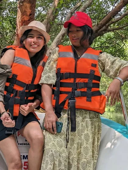 Two travelers enjoying a boat ride through the Pichavaram mangrove forest near Pondicherry.