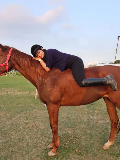 Resting on her horse after a ride. These quiet moments of connection are just as important as the ride itself.