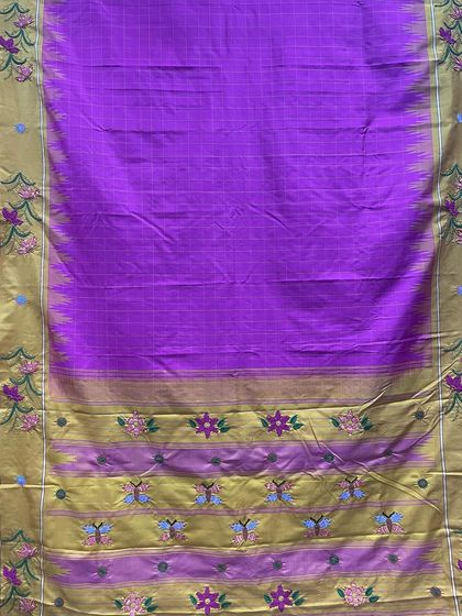 Another perspective of the custom-made Kanjeevaram silk saree, showing the arrangement of the Kamal Kadai embroidered flowers and butterflies along the border.