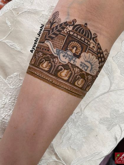 A close-up of the 'Atmadipo Bhava' (be your own light) armband, a beautiful and meaningful addition to a bridal design.