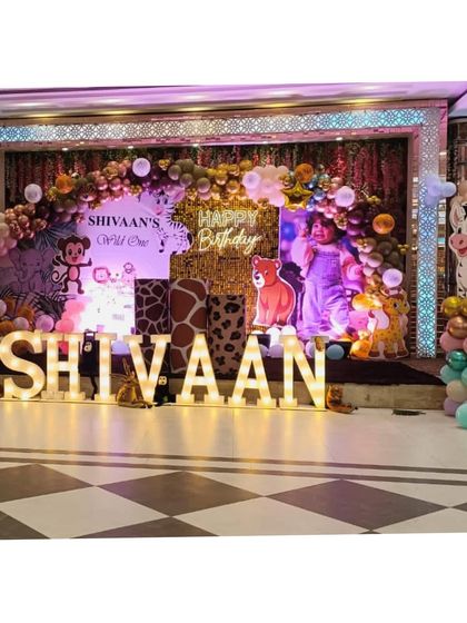 A full stage setup for 'SHIVAAN'S Wild One', featuring animal print columns, character cutouts, and large marquee letters.