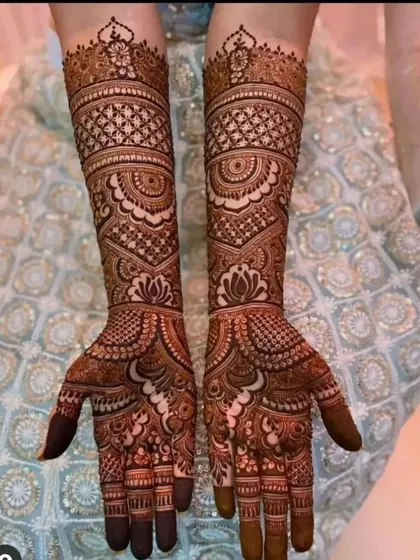 This design showcases a beautiful blend of traditional patterns, including jaali work and lotus motifs, for a classic bridal look.