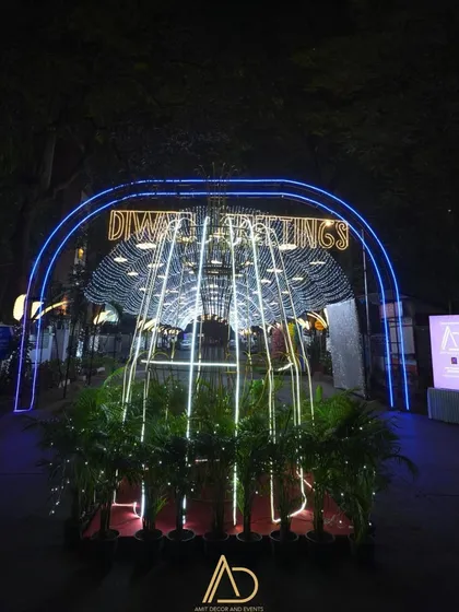 The entrance to the Diwali light tunnel, featuring a neon sign with festive greetings, welcoming everyone to the celebration.