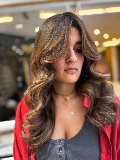 Another angle of the no-bleach balayage, with the hair styled in glamorous waves to show off the color's depth.