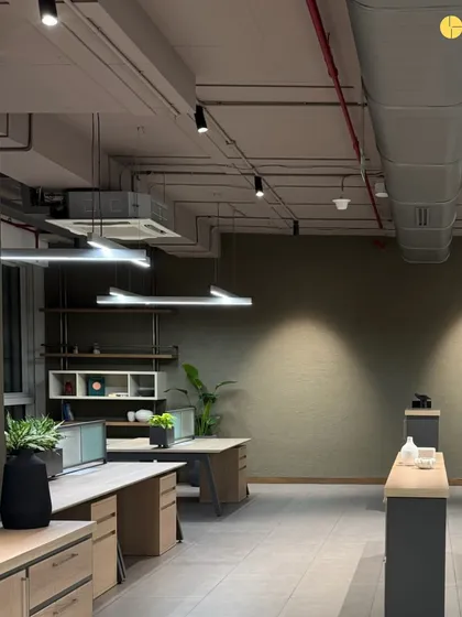 The general workstation area in 'Project LH.' The open-plan layout is designed to be flexible, with exposed ceilings and ductwork adding to the industrial-chic aesthetic. The color palette is kept neutral and calming to promote focus.