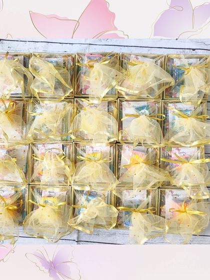 This delightful return gift hamper includes a piggy bank, a magic water color book, rolling crayons, and a 6-in-1 board game, all packed in a beautiful box with net wrapping.