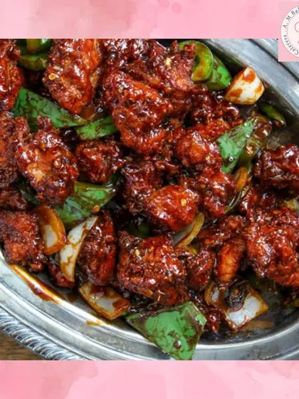 A close-up of our spicy and tangy Chilli Chicken, a must-have from our Indo-Chinese menu. Each piece is coated in a flavourful sauce with fresh capsicum and onions, making it a perfect starter for parties.