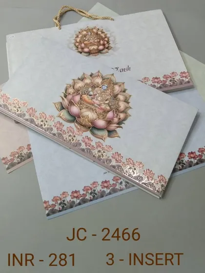 This invitation set is adorned with a beautiful illustration of a goddess seated on a lotus. The design is serene and auspicious, and it comes with a matching carry bag.