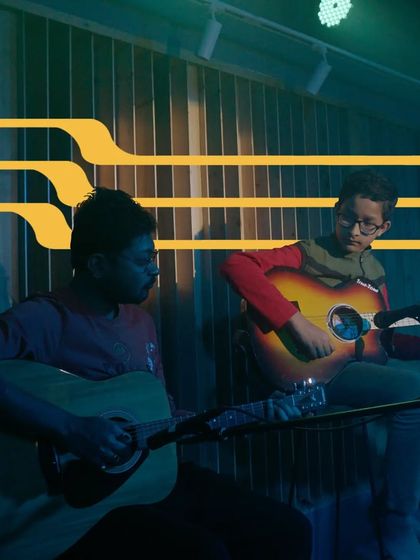 A mentor and student performing a guitar duet. Our faculty often joins students on stage, creating a collaborative and supportive learning environment.