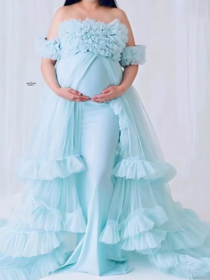 This powder blue off-shoulder maternity gown is a dreamy and delicate option. The fitted bodice and ruffled, layered skirt create a beautiful mermaid silhouette.