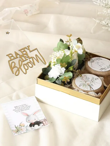 Thoughtful treats for your special day. This "Baby in Bloom" return favor hamper includes a jar of almond cookies and a jar of decadent brownie bites.