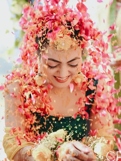 The Haldi ceremony is all about pure, uninhibited joy. I aim to freeze these moments of laughter and celebration, like this shower of petals, capturing the vibrant energy that makes Indian weddings so special.