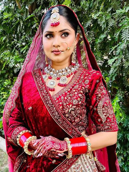 A full shot of the bride, where her mehndi-adorned hands are a key part of her stunning look.
