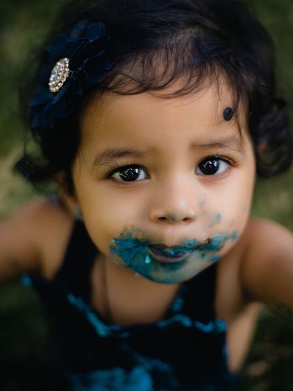 A duplicate of image 44, a compelling close-up of a one-year-old's face covered in blue frosting.