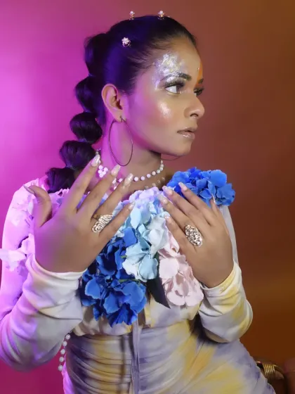 A side profile from the fantasy shoot, highlighting the glittery eye makeup and bubble braid hairstyle.