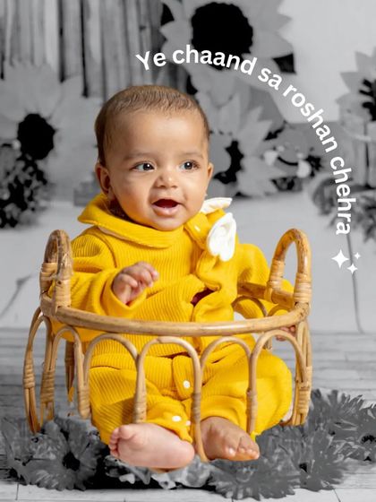 This happy baby, dressed in a bright yellow outfit, smiles from a wicker prop. The color-splash effect makes his joyful expression the undeniable focus of the portrait.