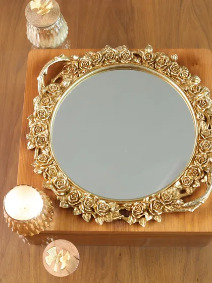 Our round mirror tray with a detailed rose-bordered frame, shown here with candles. It’s a piece that exudes romantic elegance, perfect for serving or as a decorative accent.