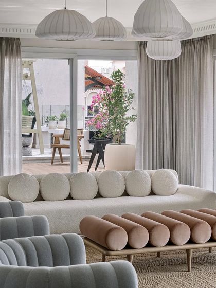 Another view of the living room, highlighting the interplay of rich materials and jewel-toned colors. The space feels whimsical yet tranquil, bold yet balanced.
