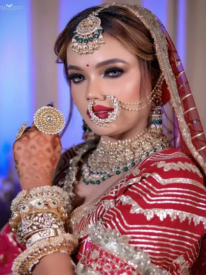 A bold portrait of the bride showing off her large, traditional rings and confident expression.