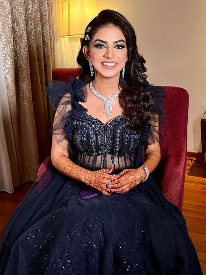 A full-length shot of Aditi's gorgeous navy blue engagement gown. The smokey eye makeup ties the whole look together.