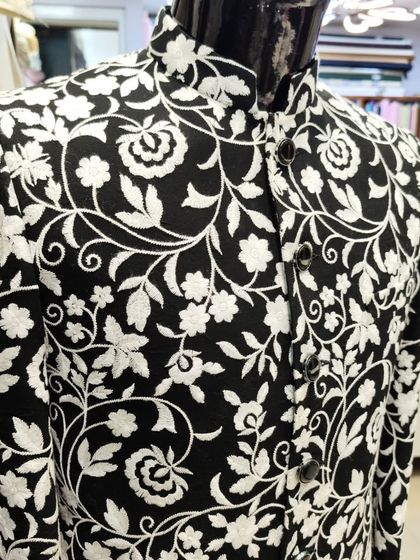 A close-up of the black and white floral print Jodhpuri, showing the intricate design and clean tailoring.