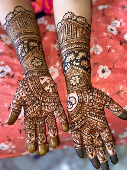 This design features a heart with the couple's initials on one palm and wedding rings on the other, surrounded by floral and lotus motifs.