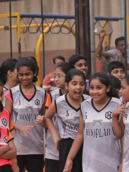 Young players from the girls' division sharing a smile during the tournament. It's a playground for everyone to grow and shine.