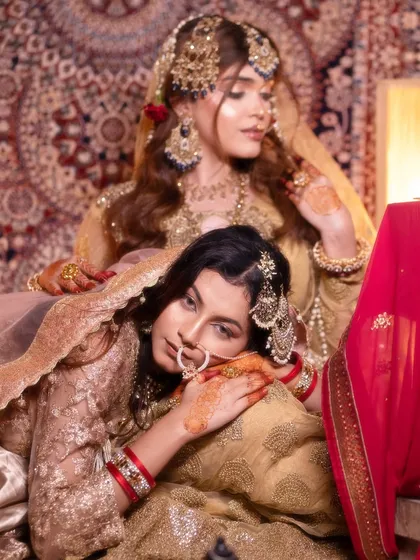 Two of my students showcasing their work in a beautifully composed shot, highlighting different but complementary traditional makeup styles.